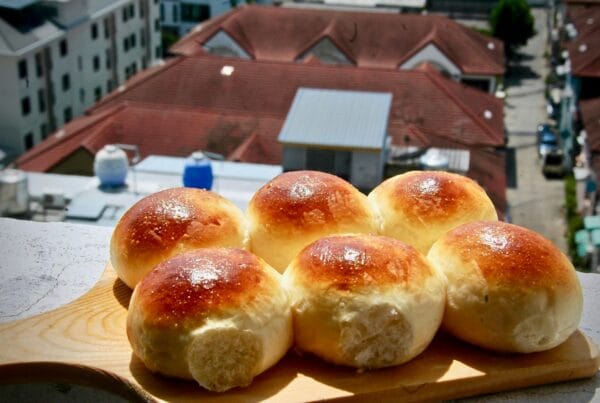 Pan de coco, Garifuna coconut bread rolls on a wooden board