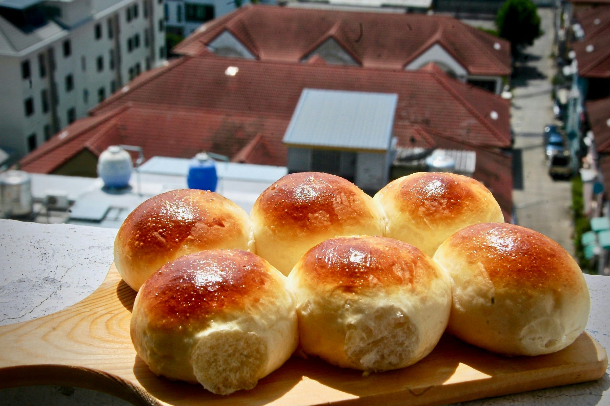 Pan de coco, Garifuna coconut bread rolls on a wooden board