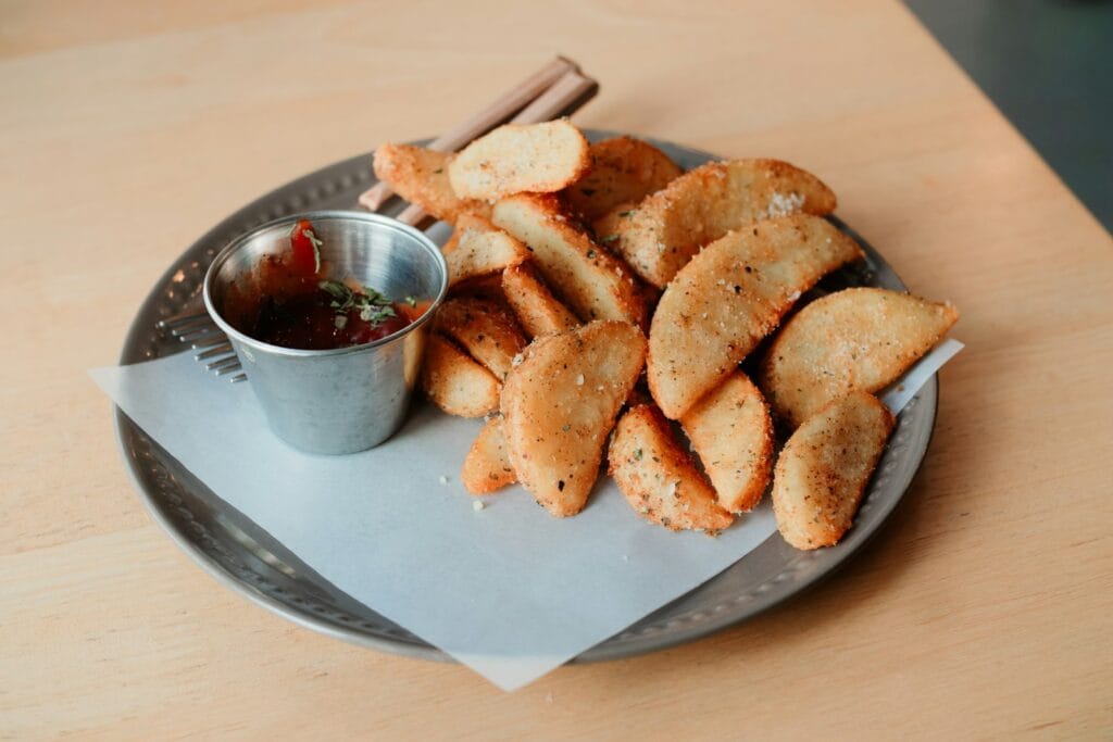Crispy Honduran pastelitos de carne, fried corn-masa turnovers served with dipping salsa