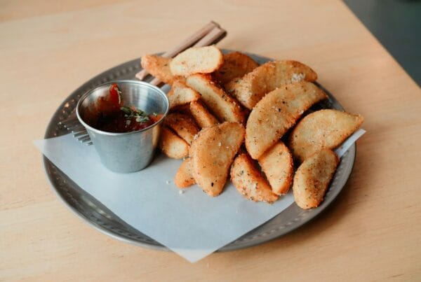 Crispy Honduran pastelitos de carne, fried corn-masa turnovers served with dipping salsa