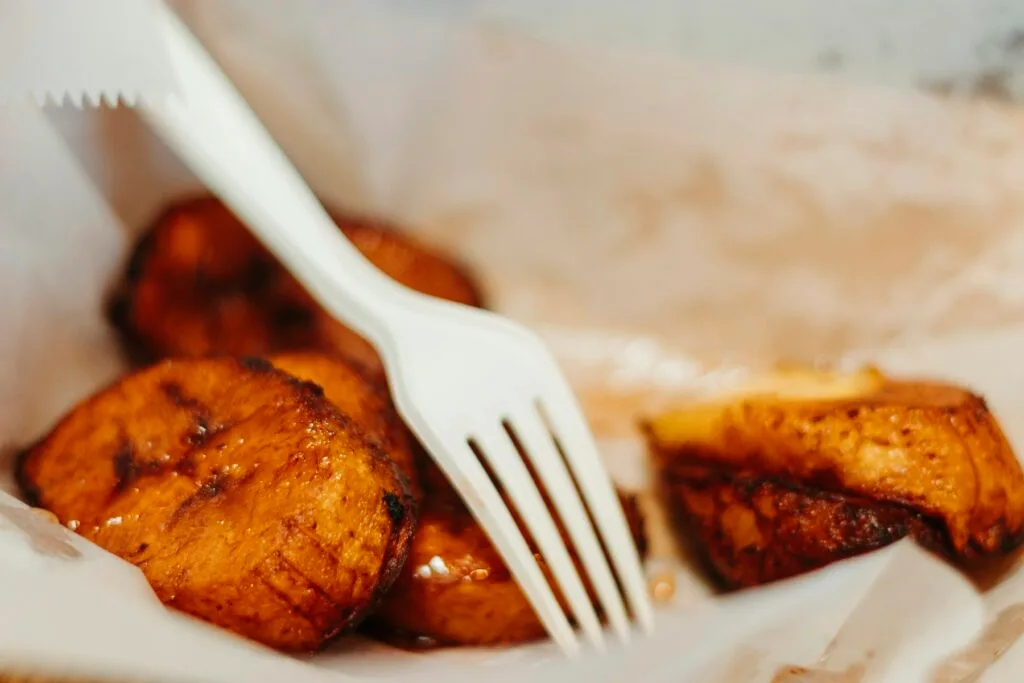 Golden caramelized plátanos fritos — fried ripe plantains served with crema salvadoreña