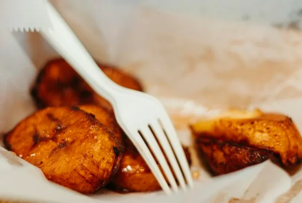 Golden caramelized plátanos fritos — fried ripe plantains served with crema salvadoreña