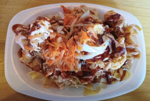 Pollo chuco, Honduran fried chicken over plantain tajadas with slaw and sauces