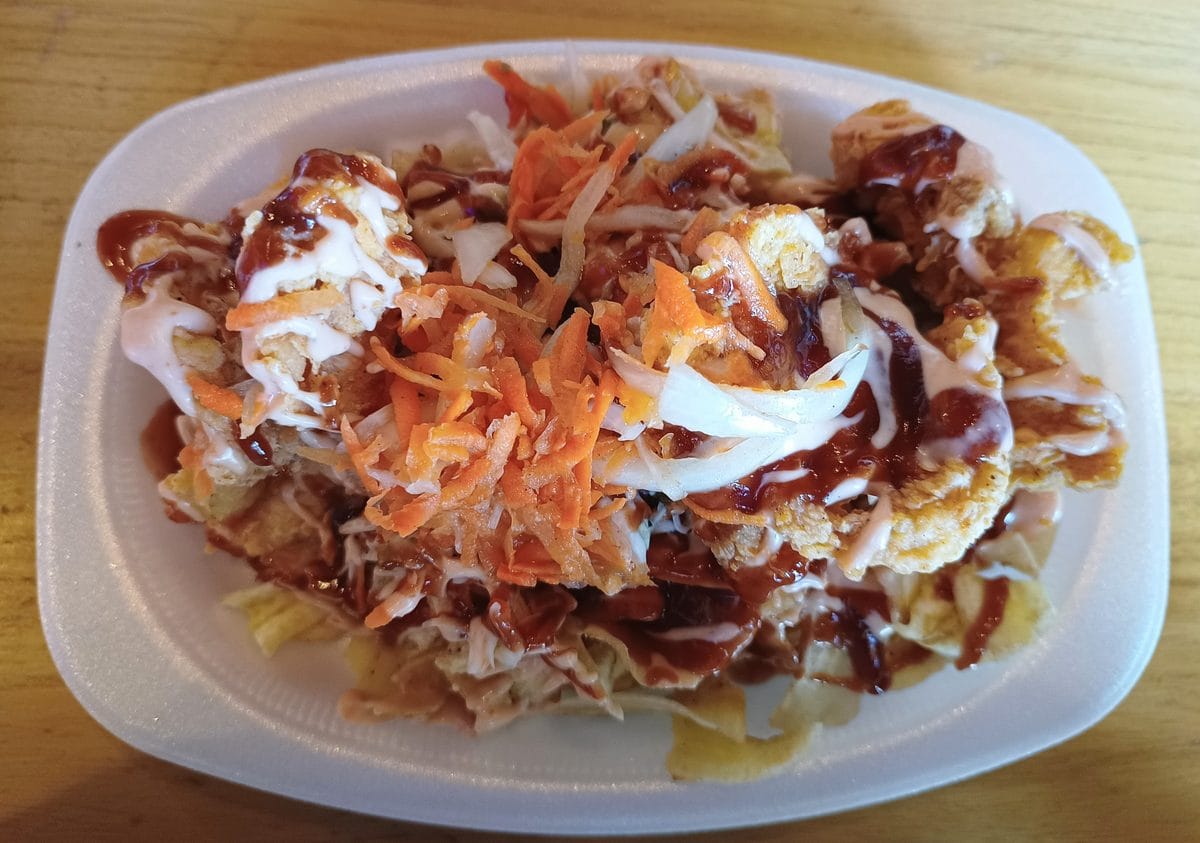Pollo chuco, Honduran fried chicken over plantain tajadas with slaw and sauces