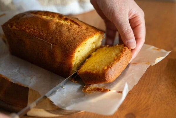 Quesadilla salvadoreña, a golden cheese pound cake, being sliced