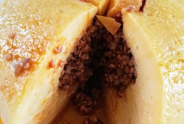 Queso relleno yucateco, a ball of Edam cheese stuffed with pork picadillo