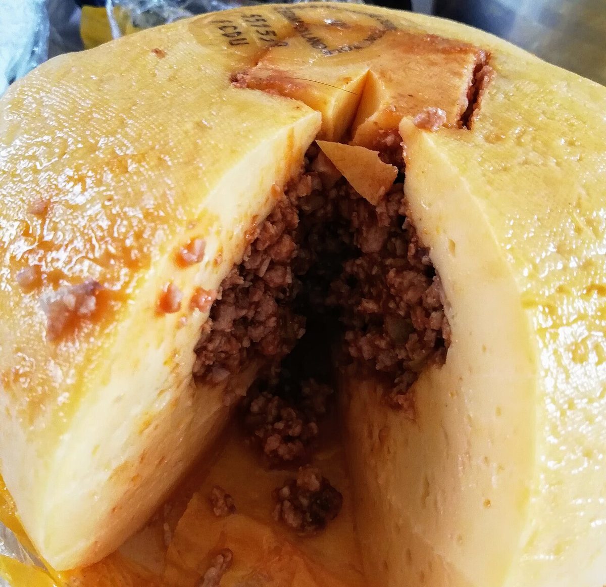 Queso relleno yucateco, a ball of Edam cheese stuffed with pork picadillo