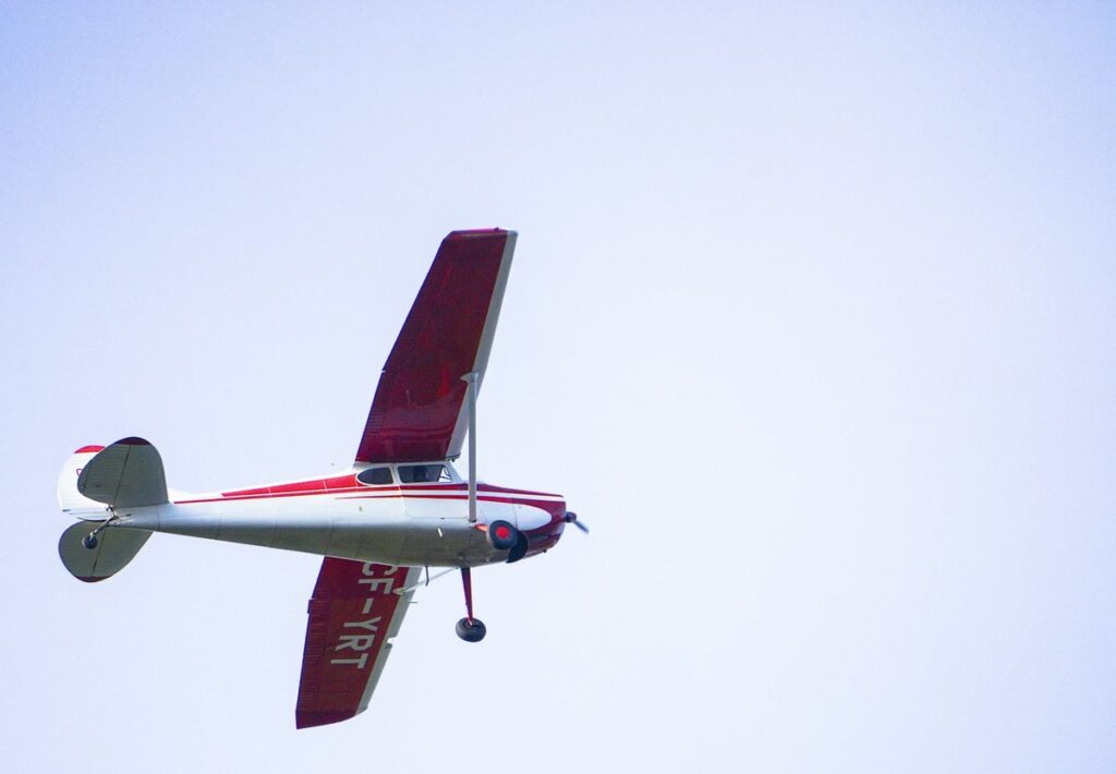A small single-engine propeller plane in flight