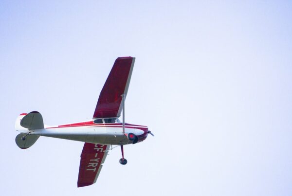 A small single-engine propeller plane in flight