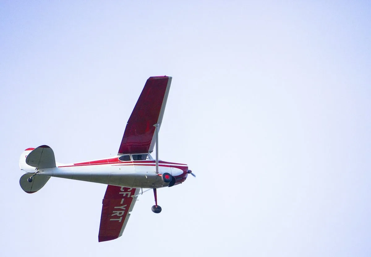 A small single-engine propeller plane in flight