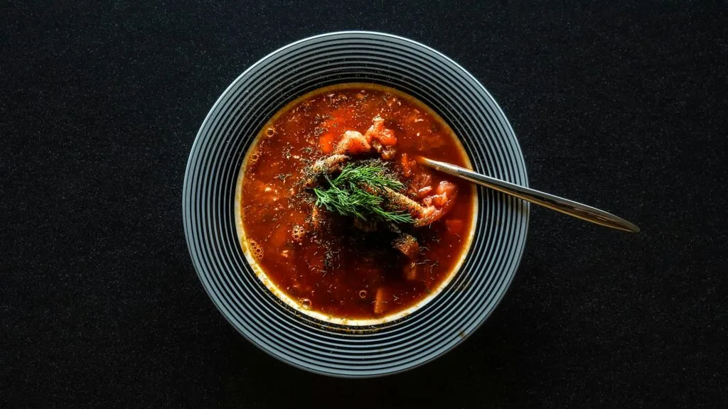 Bowl of Honduran sopa de frijoles, a dark savory red bean soup