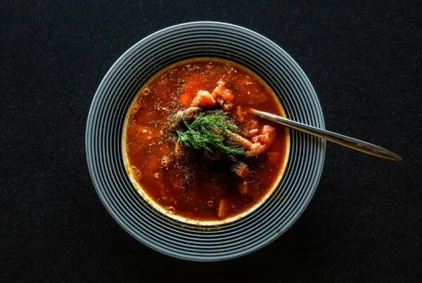 Bowl of Honduran sopa de frijoles, a dark savory red bean soup