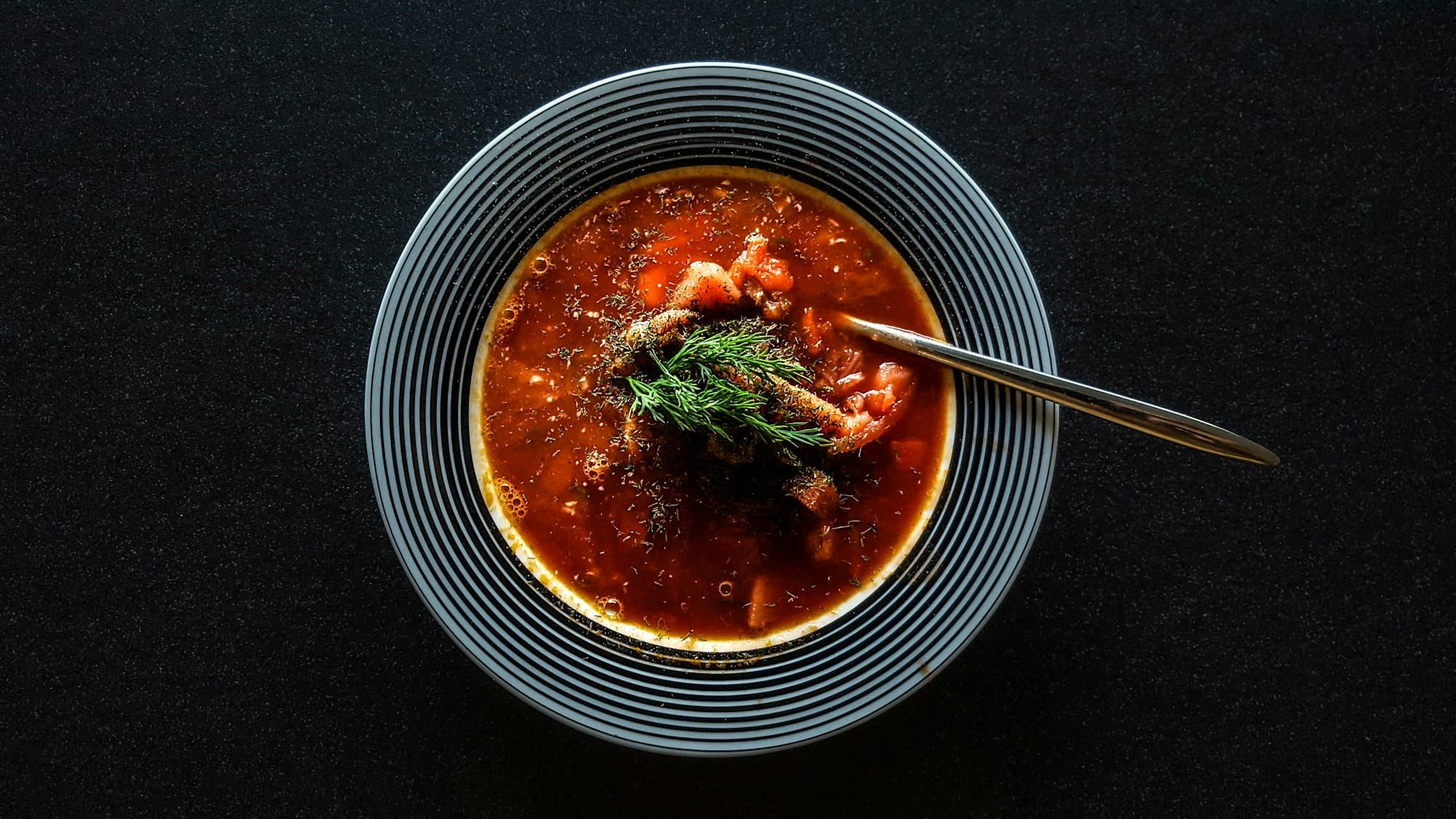 Bowl of Honduran sopa de frijoles, a dark savory red bean soup
