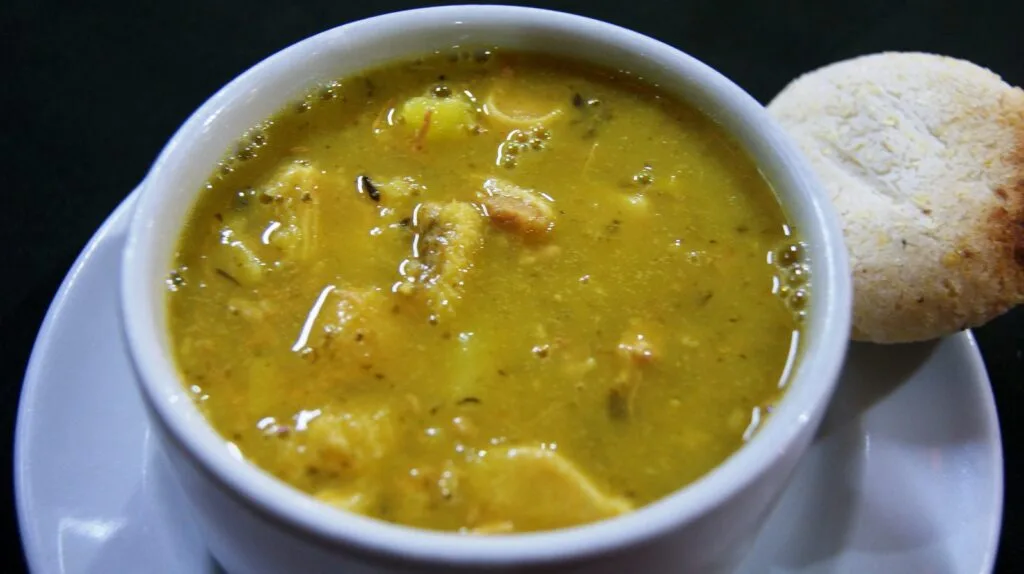 Bowl of Honduran sopa de mondongo with tripe, yuca, plantain, and corn