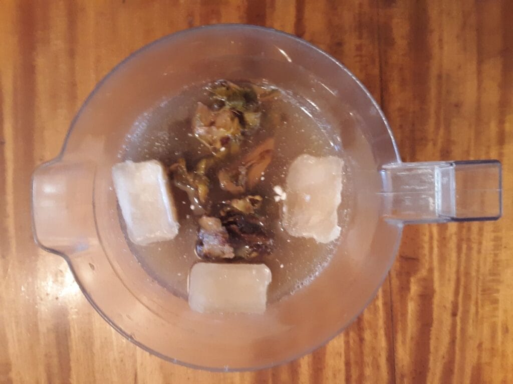 Chicha de piña, pineapple rinds steeping with spice, the fermented pineapple-panela base behind gallo en chicha