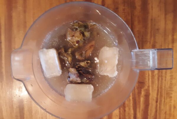 Chicha de piña, pineapple rinds steeping with spice, the fermented pineapple-panela base behind gallo en chicha