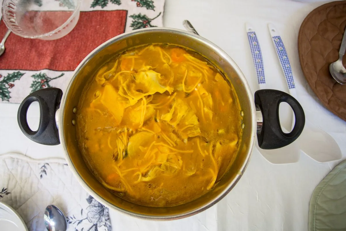 Haitian soup joumou, a golden squash soup with beef, root vegetables, and pasta