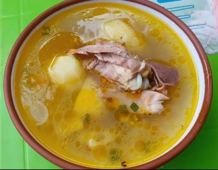 Salvadoran sopa de gallina india, a clear hen broth with vegetables