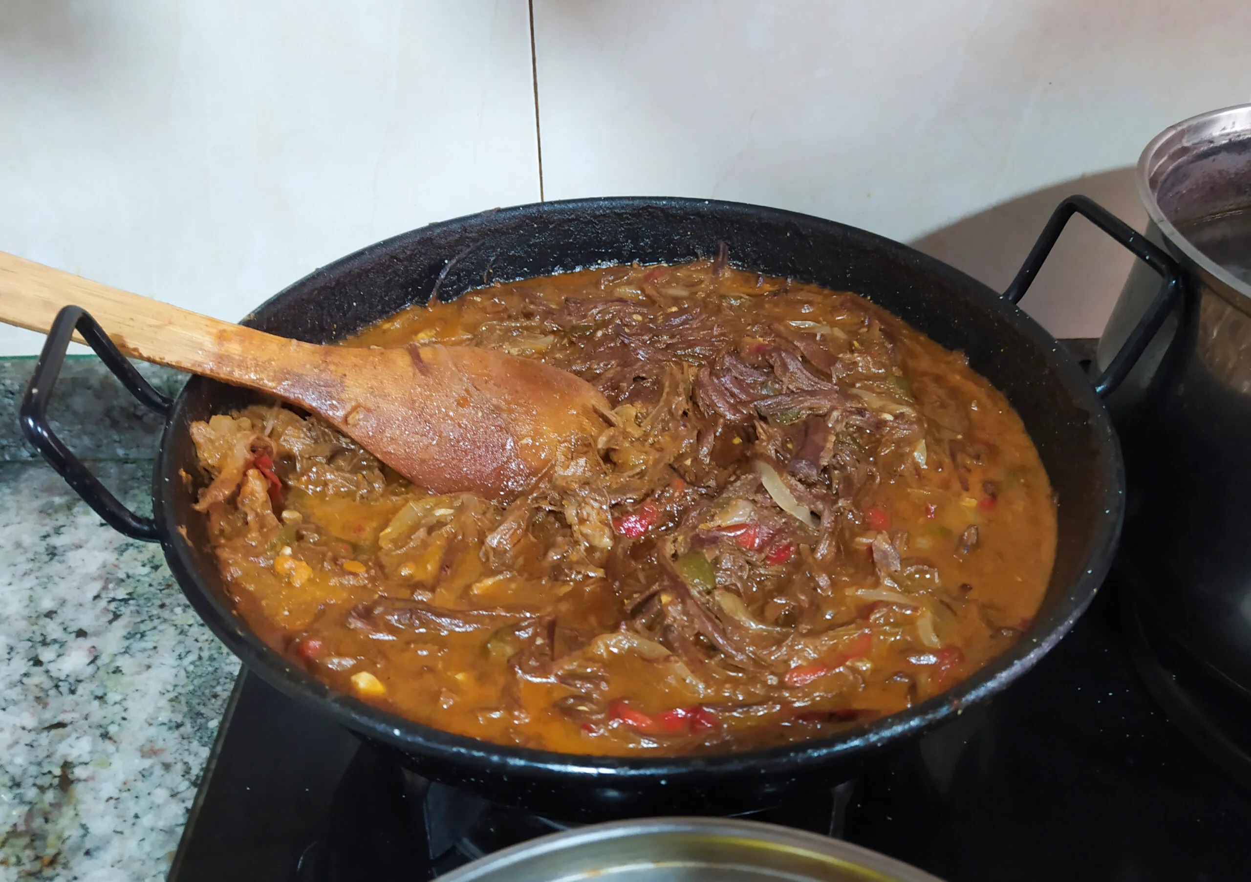 Cuban ropa vieja, shredded beef in tomato sofrito, served with white rice