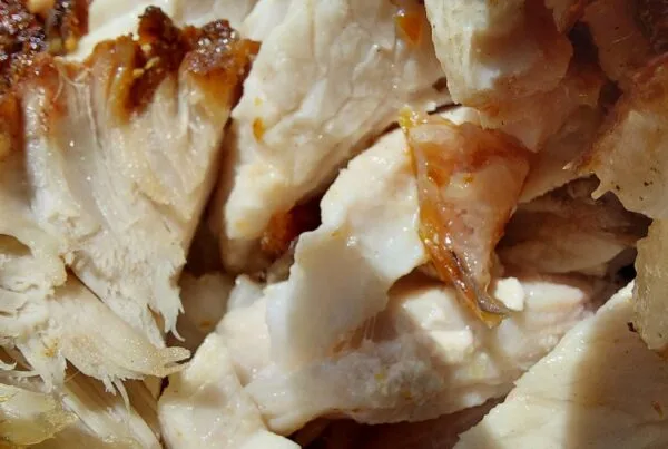 Roast pork sliced, showing crisp browned skin and pale interior