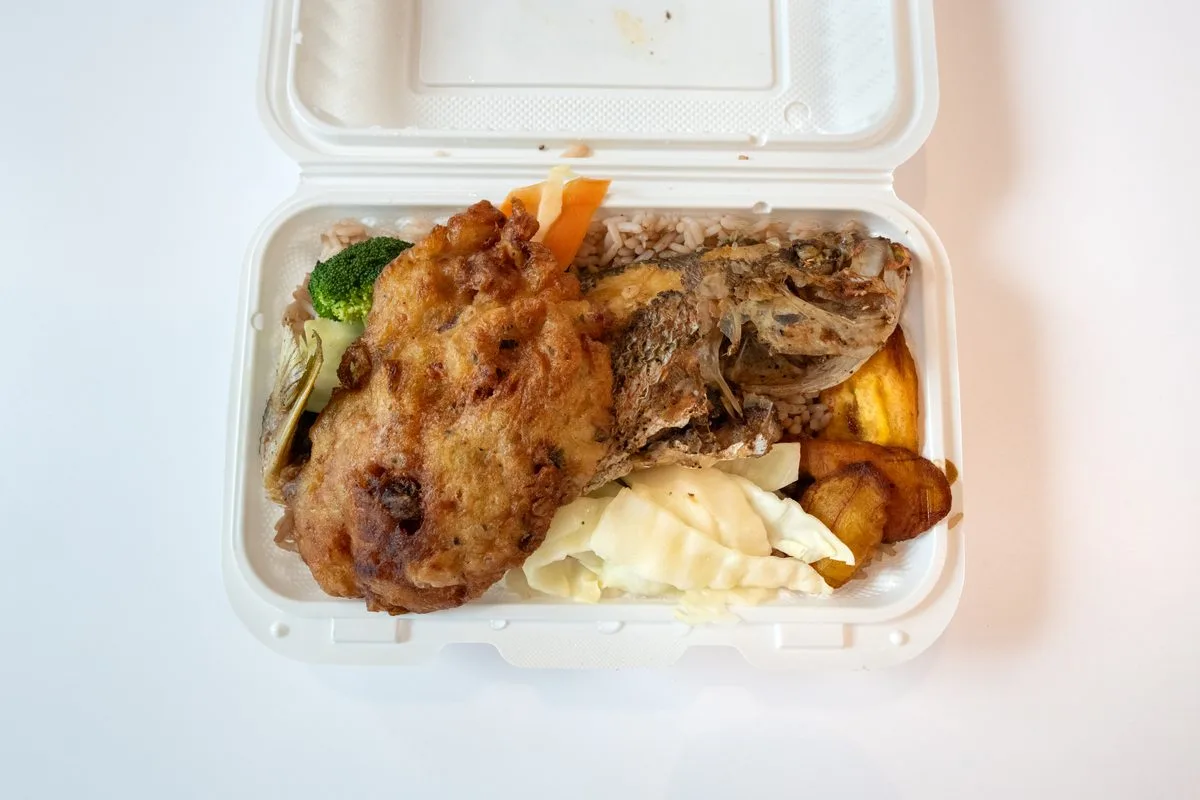 Jamaican escovitch fish with fried plantains and vegetables over rice