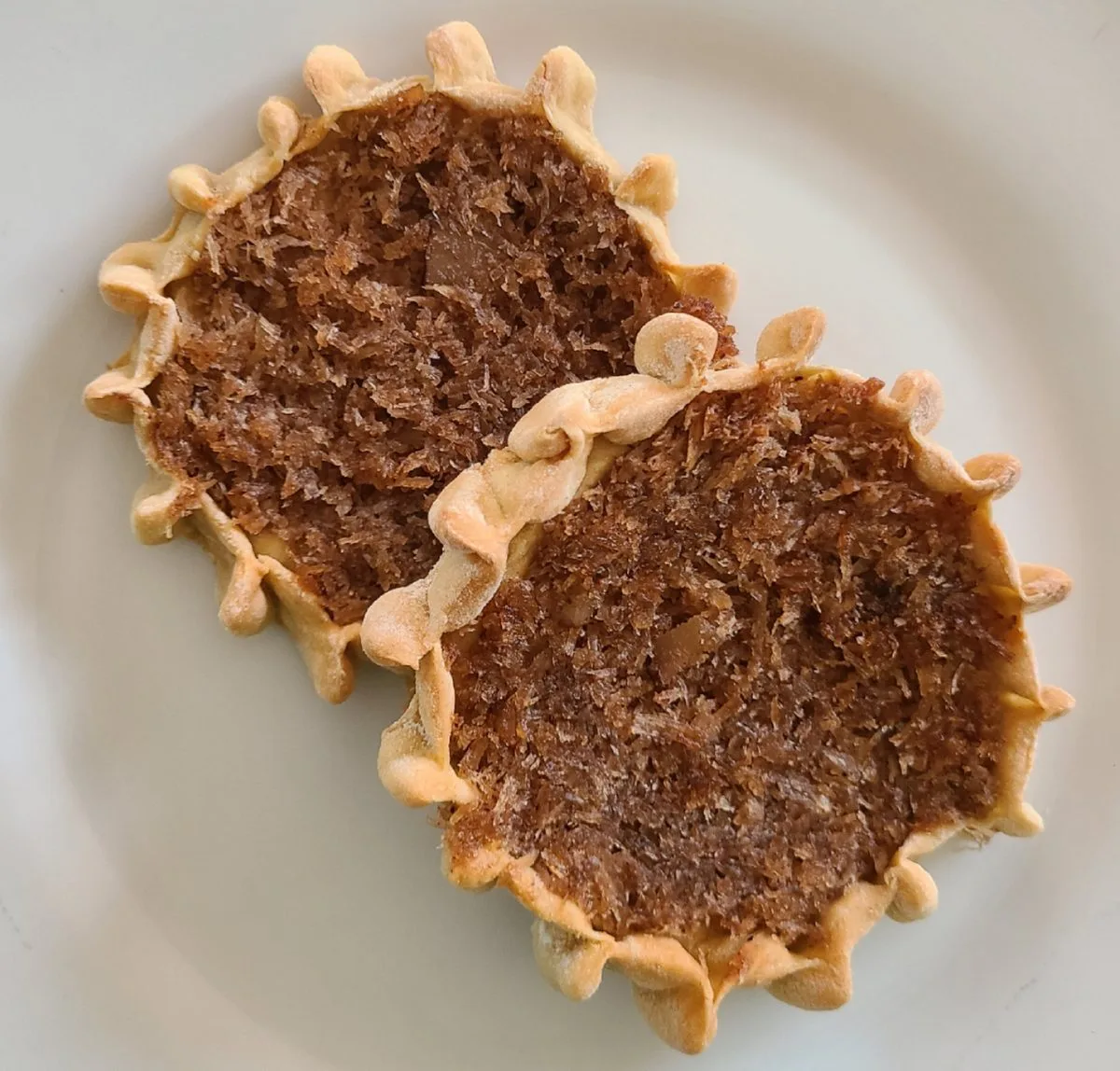 Jamaican gizzada, open coconut tarts with pinched pastry rims