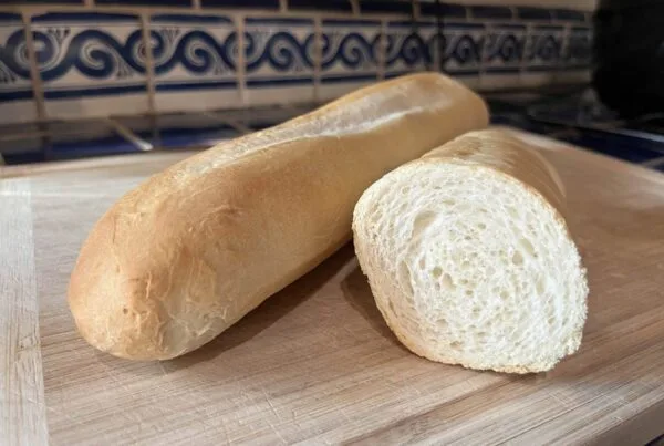 A long oval loaf of white bread with a seam running the length of the crust