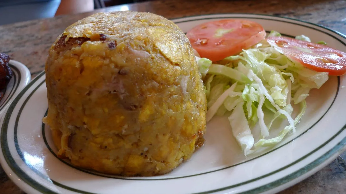 Dome of Puerto Rican mofongo with chicharron, served with salad
