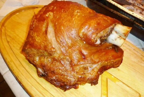 puerto rican pernil, whole bone-in pork shoulder roasted with crisp golden cuerito