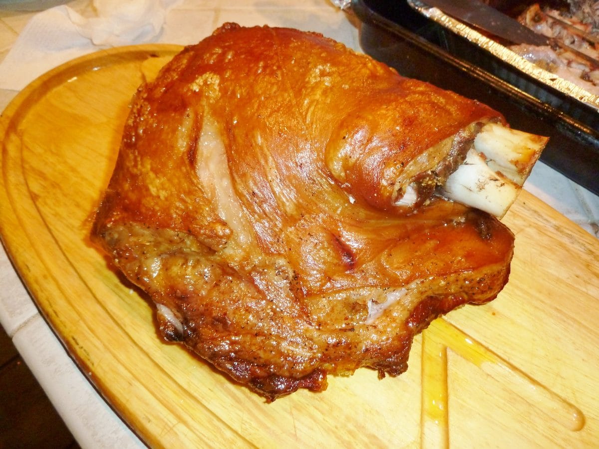 puerto rican pernil, whole bone-in pork shoulder roasted with crisp golden cuerito