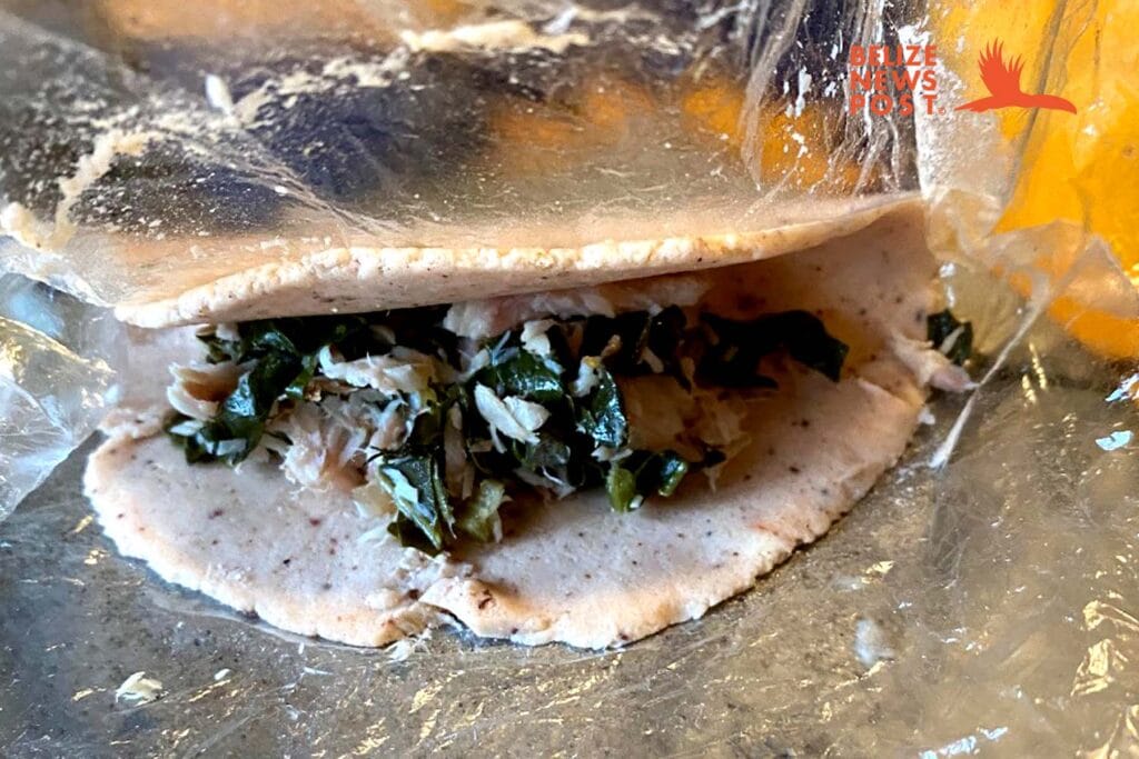 Gently folding the panades maseca dough over and sealing the panades.