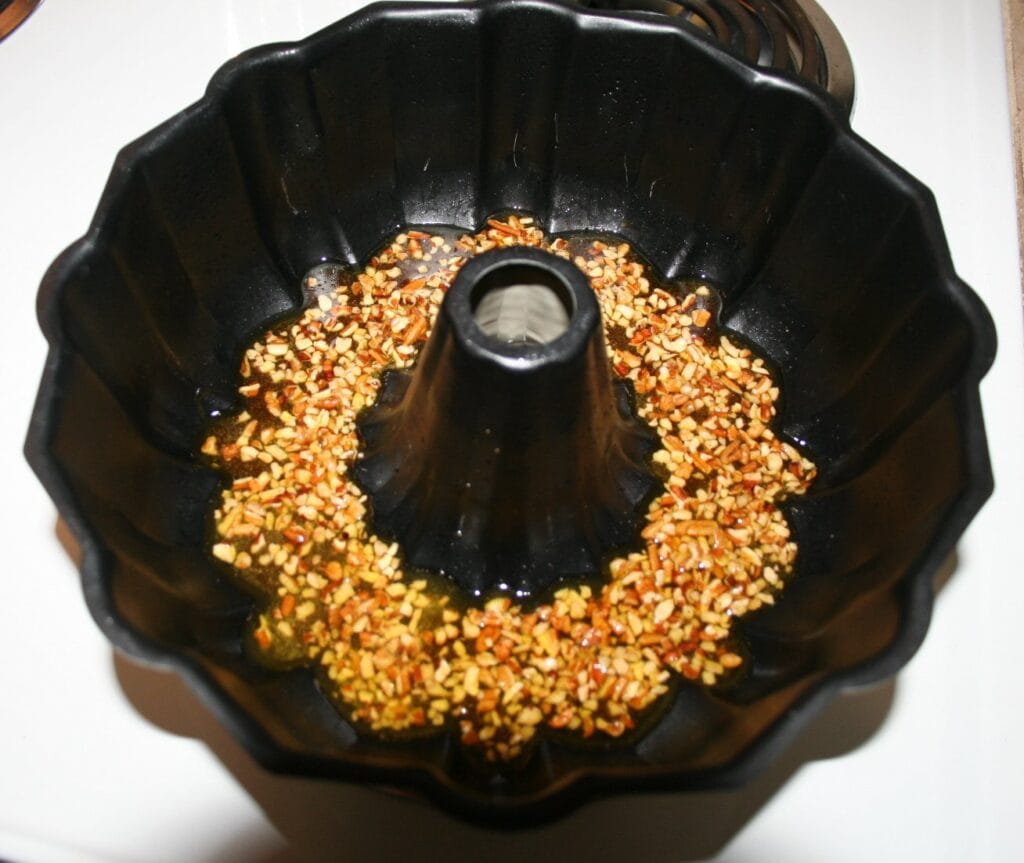 Belizean Rum Cake topping in bottom of Bundt pan