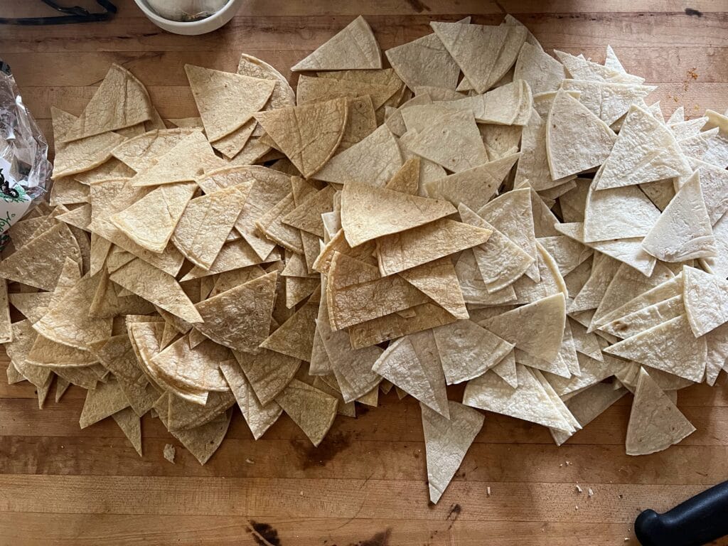 Raw tortilla chips ready to fry.