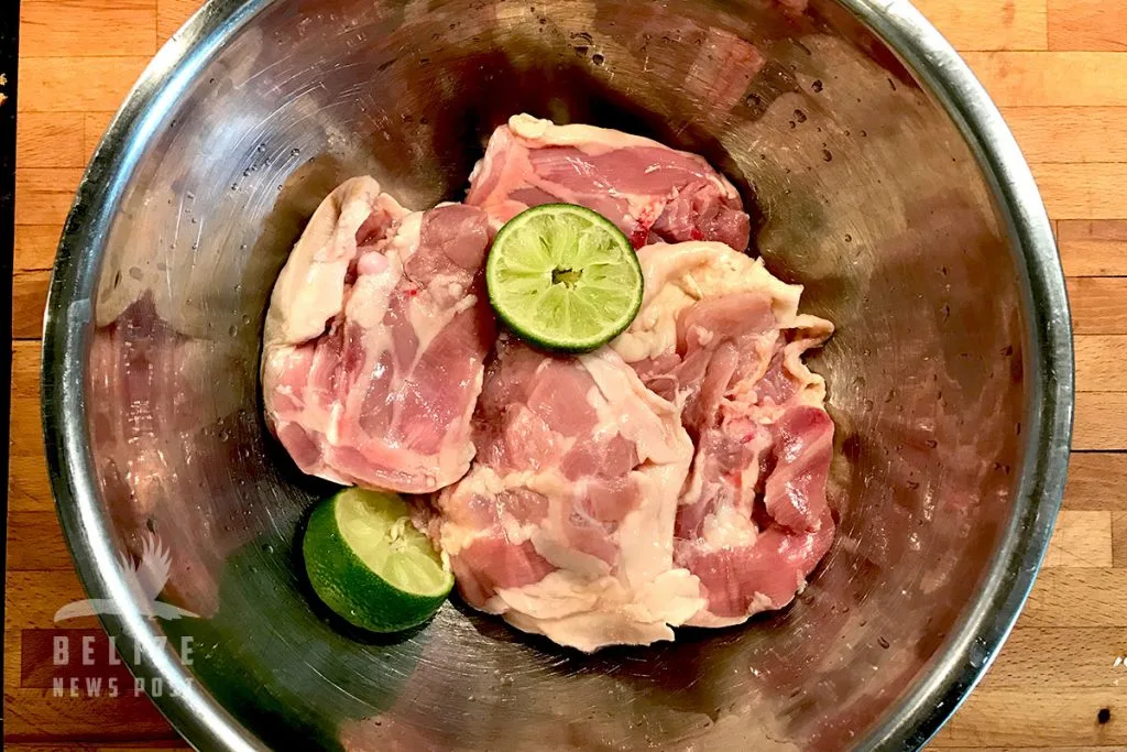 Chicken pieces browning in a heavy pot for Belize stew chicken