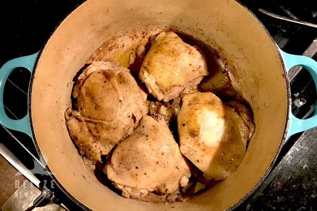 Onion and garlic added to the pot with the browned chicken