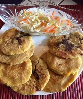 Papusas cooking on a griddle