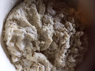 Recipe Step - Sifting bread flour into the dough mixture.
