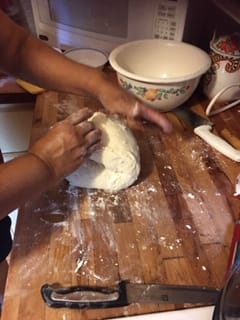 Creole Bread Recipe Step - Kneading the dough on a floured surface.
