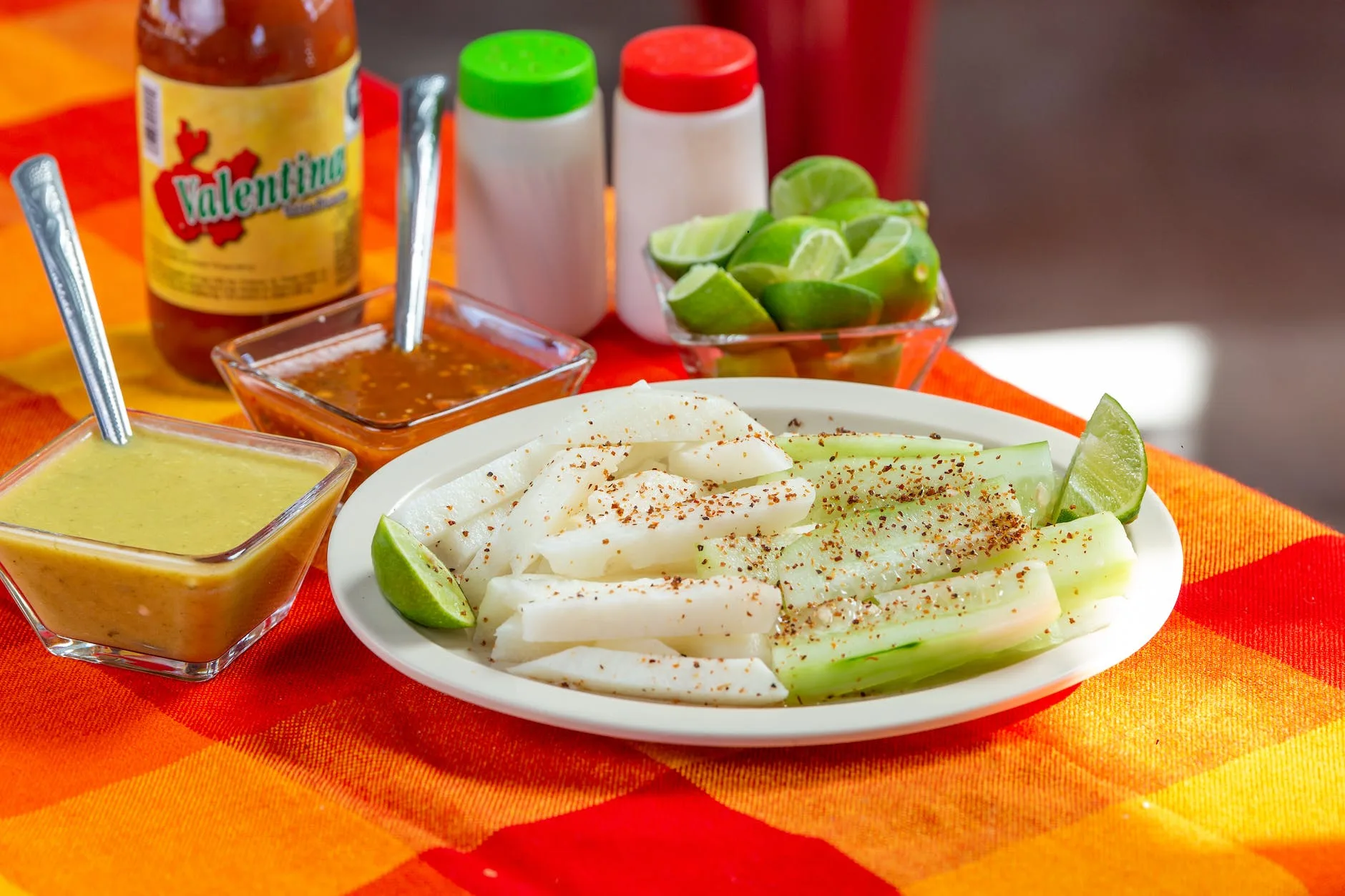 plate of jicamas with chili powder and dipping sauces