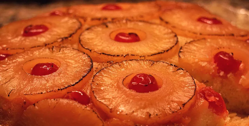 Belizean Pineapple Upside Down Cake Recipe Completed with Lightly Toasted Rings of Pineapple with Cherries in the Middle of each Slice of Pineapple. Recipe by Belize News Post.
