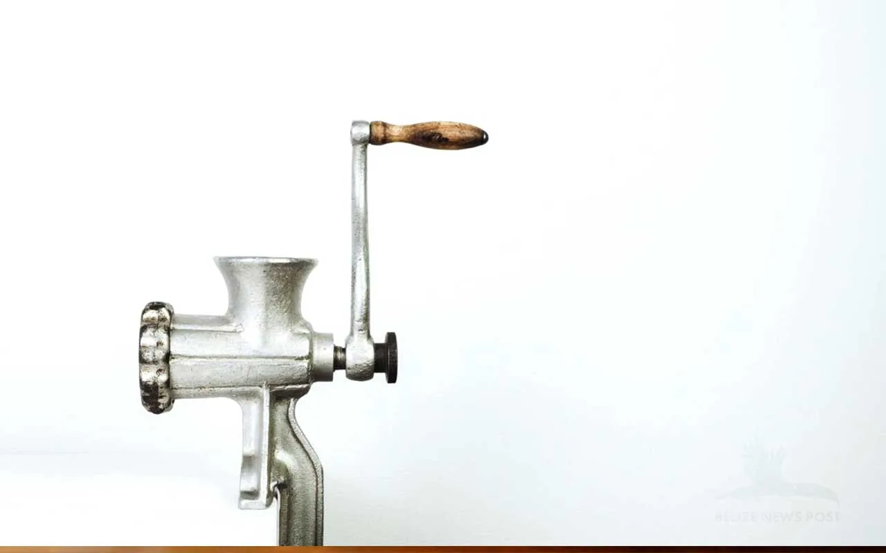 Hand-cranked meat grinder with a spice attachment used for grinding red recado in Corozal