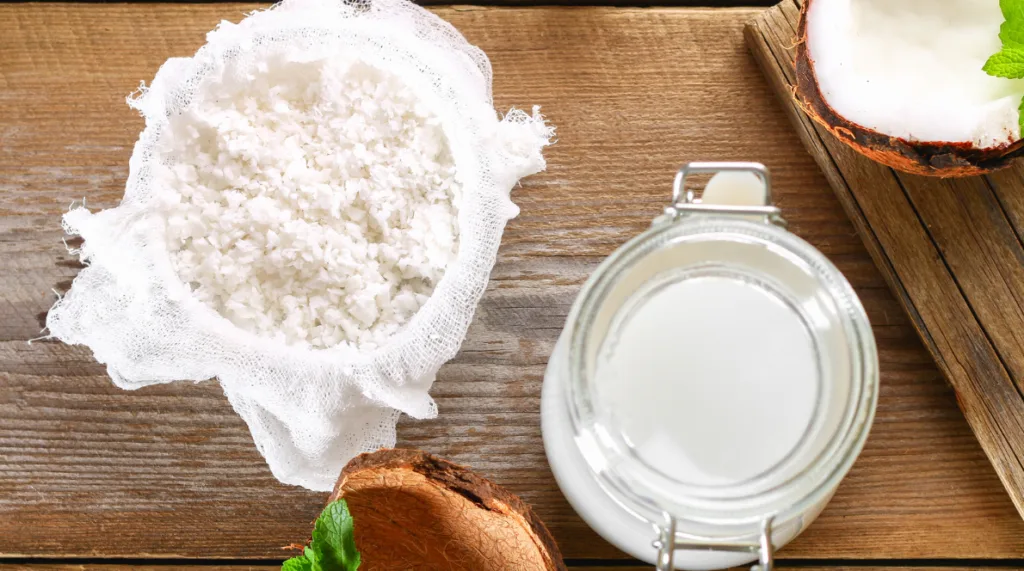 Extracting coconut milk from freshly grated coconut for use in Belize cooking.